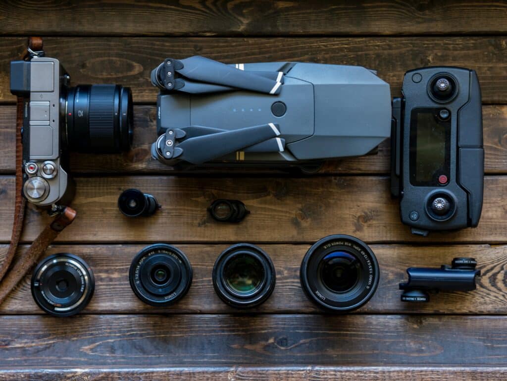 drone and camera equipment lined up on table