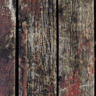 Dark, faded, wooden planks with patches of red, representing Claim 8: Wood Rot