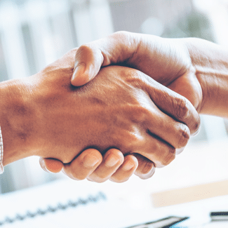 Two different hands (both tan) shaking in agreement, signifying the pre-inspection agreement as an inspector's first line of defense