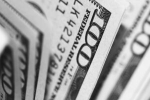A stack of hundred dollar bills, alluding to questions about the first year inspecting like, do home inspectors make good money after starting a home inspector company?