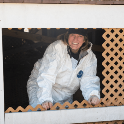 Alajajian Giroux smiling from a crawlspace during an inspection