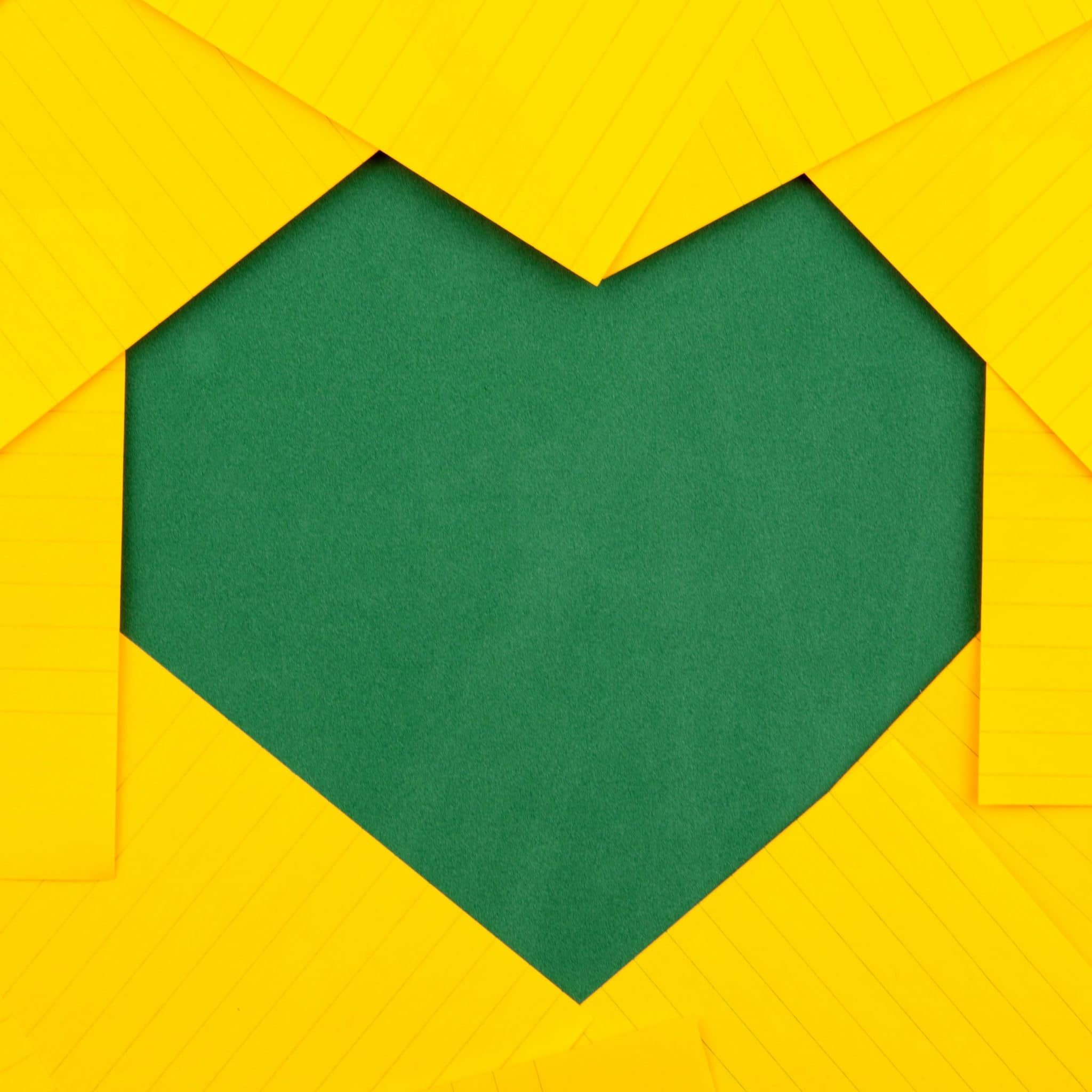 Green heart on top of yellow background