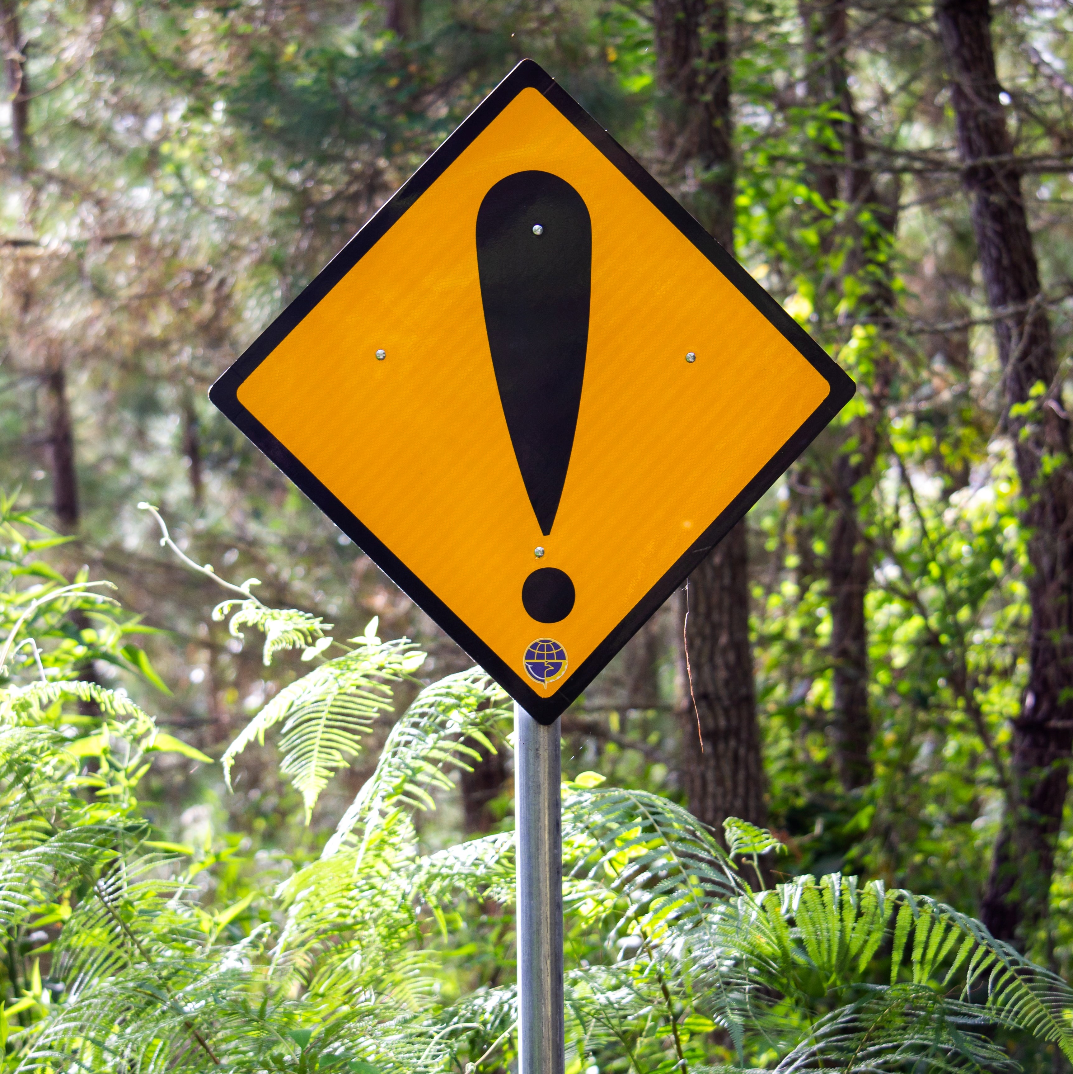 Yellow road sign with black exclamation mark 