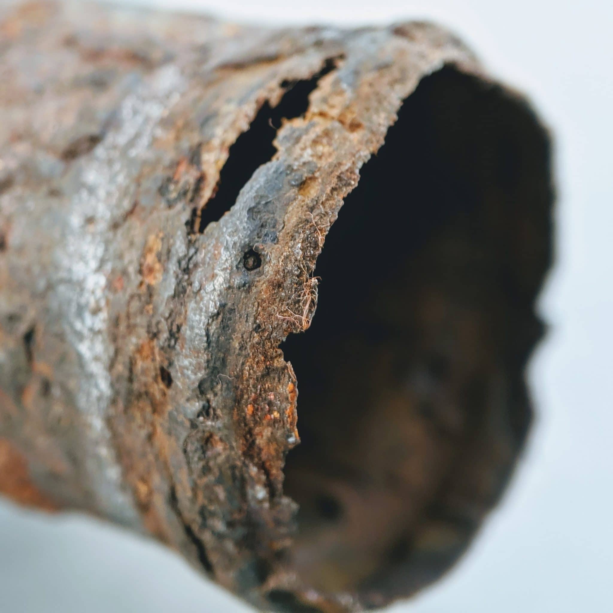 Rusted and cracked cast iron plumbing pipe