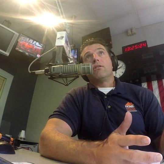 Preston Sandlin in a navy blue HIC shirt, recording his podcast The Successful Home Inspector in a recording studio