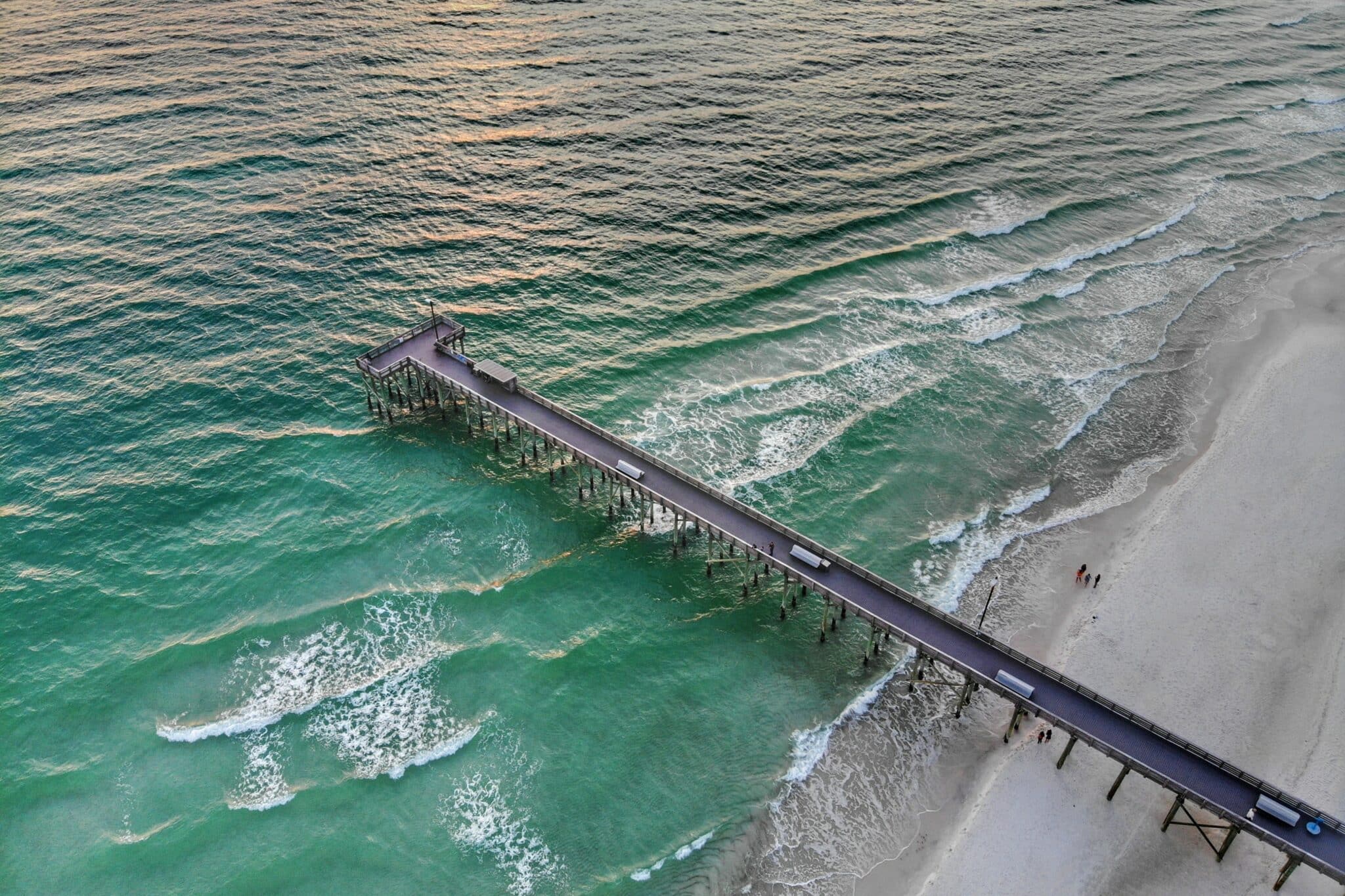 Long bridge over sand and ocean at Panama City Beach, Florida