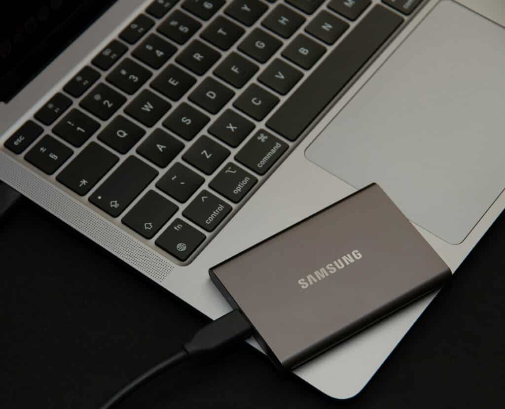 Samsung external hard drive on top of a Macbook keyboard