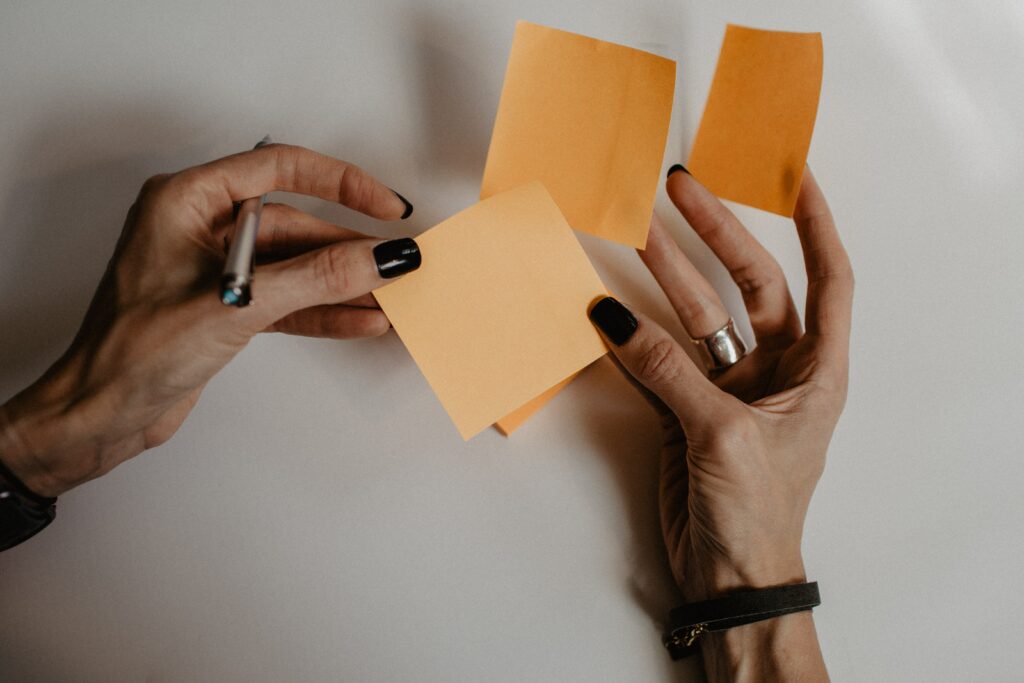 woman holding orange sticky notes