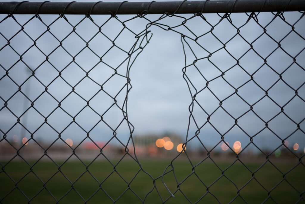 chain link fence with hole in the center