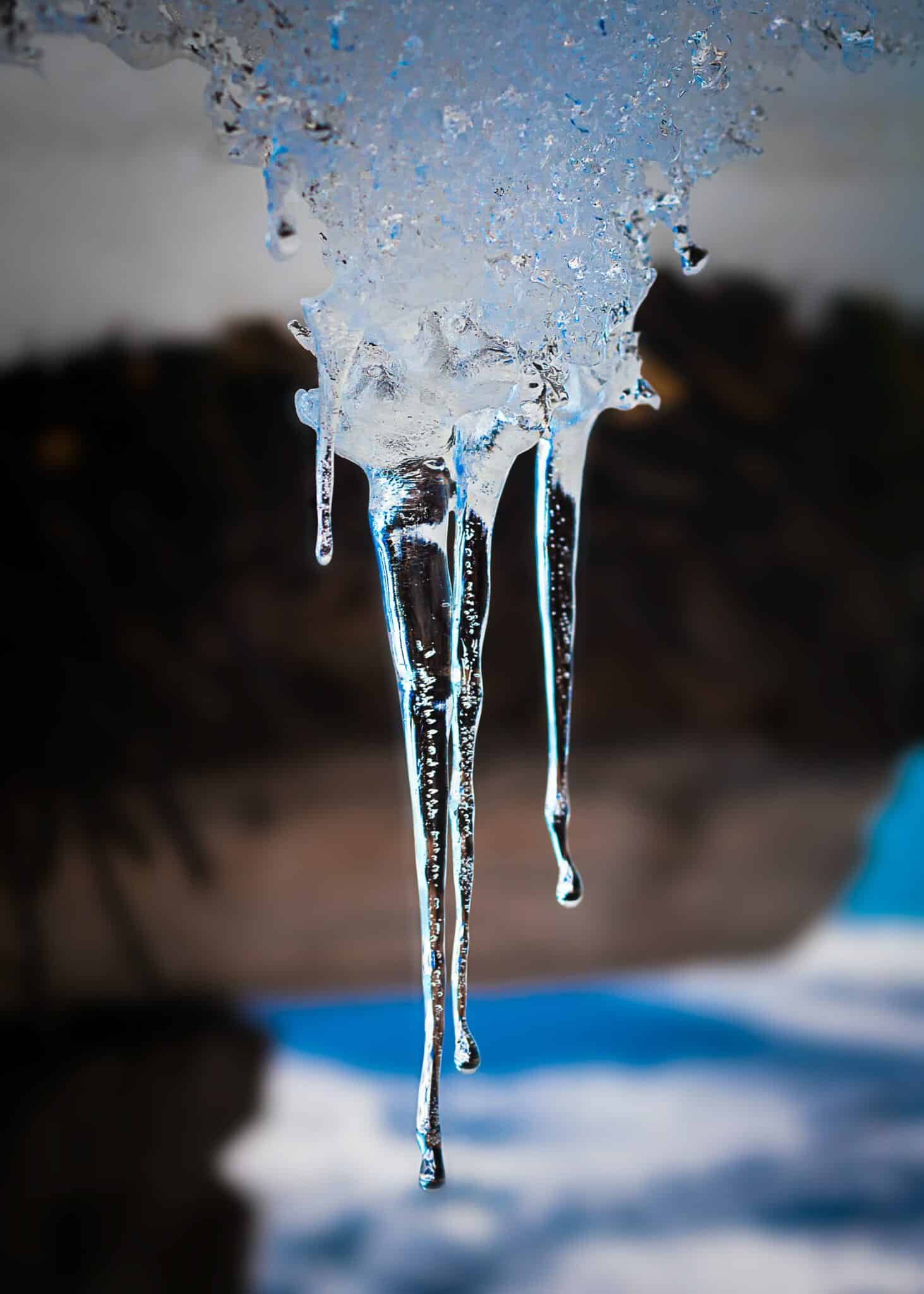 Heavy icicle hanging down off a building or natural structure