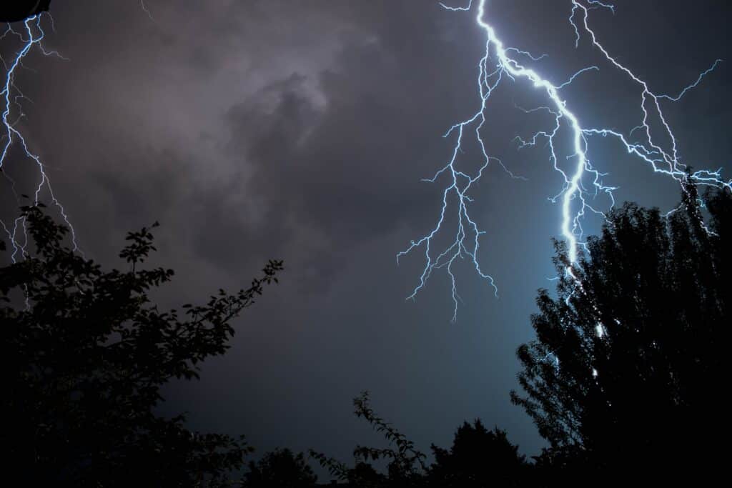 Zoomed-in image of lightning strike at night. This is one of many conditions to watch out for while performing a home inspection during extreme weather.