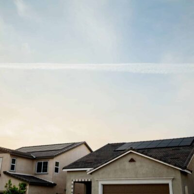 Rooftops in suburban neighborhood against a cloudy, sunset or sunrise sky. Ideal conditions for a morning roof inspection.