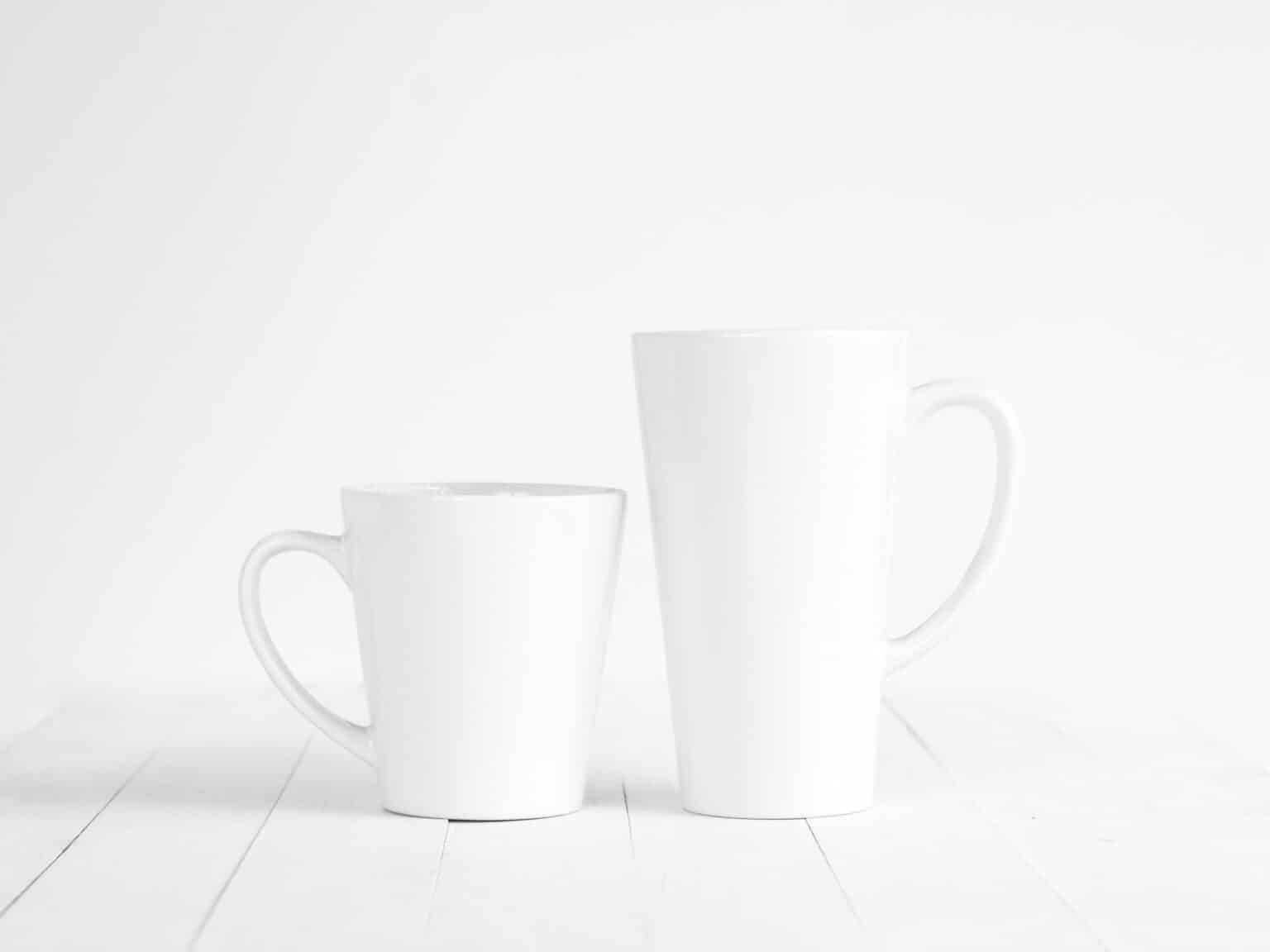 two white ceramic mugs on white background