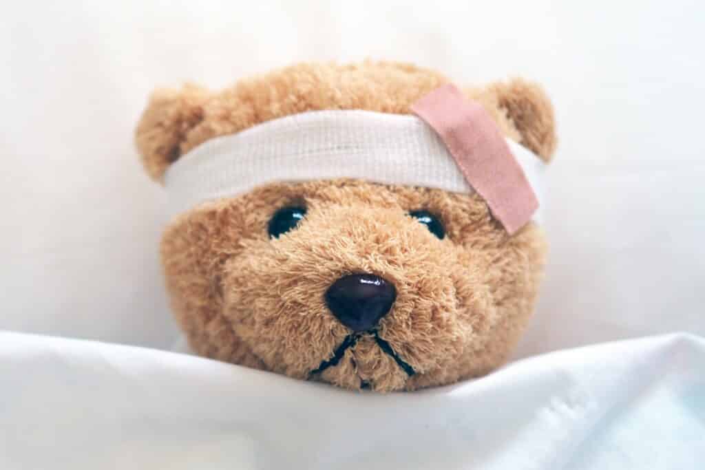 Picture of an injured teddy bear representing a client injured during a home inspection with a bandage.