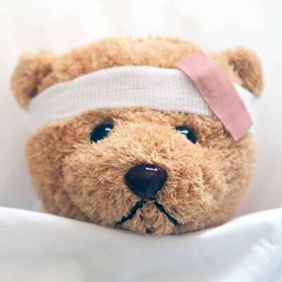 Picture of an injured teddy bear representing a client injured during a home inspection with a bandage.