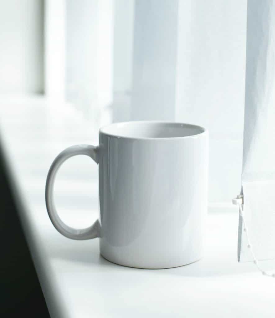 white mug on window sill