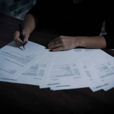 woman writing on documents