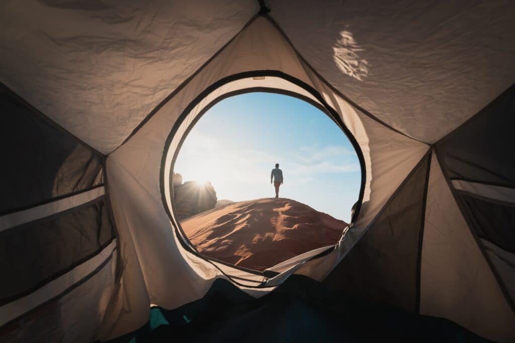 looking out of tent at man
