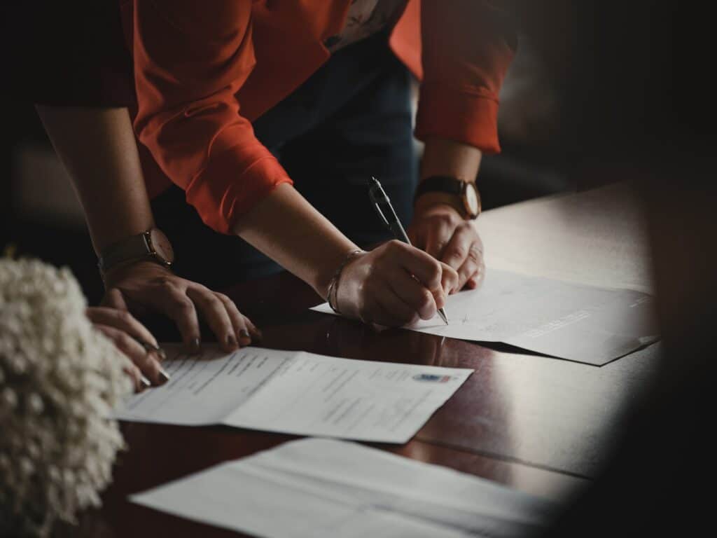 two women signing paperwork