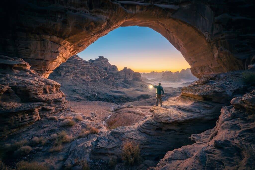 man overlooking natural rock formations