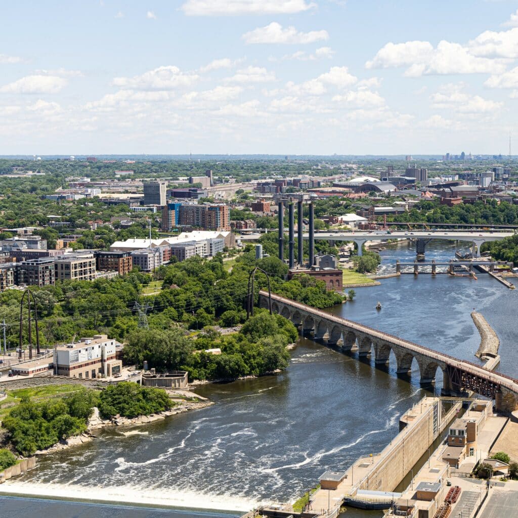 Aerial view of bridge over river during daytime in Minneapolis, Minnesota.
