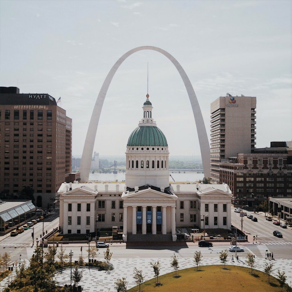 View looking down at a St. Louis, Missouri historical building with the Gateway Arch behind it.