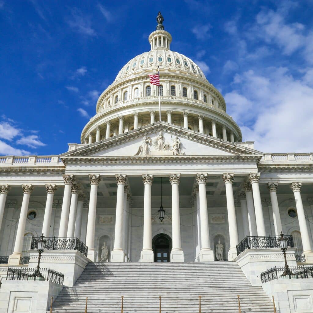 The steps leading up to the nation’s capital in Washington, DC with a bright blue sky in the background, spotted with fluffy clouds.