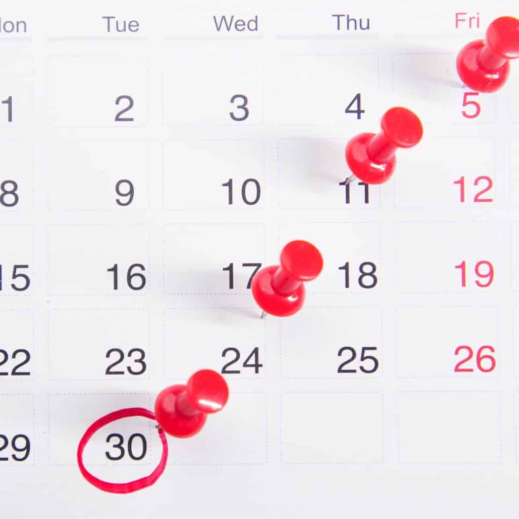 Planning ahead is crucial to getting a signed contract before a home inspection. Illustrated with a white calendar and dates marked with red pins.