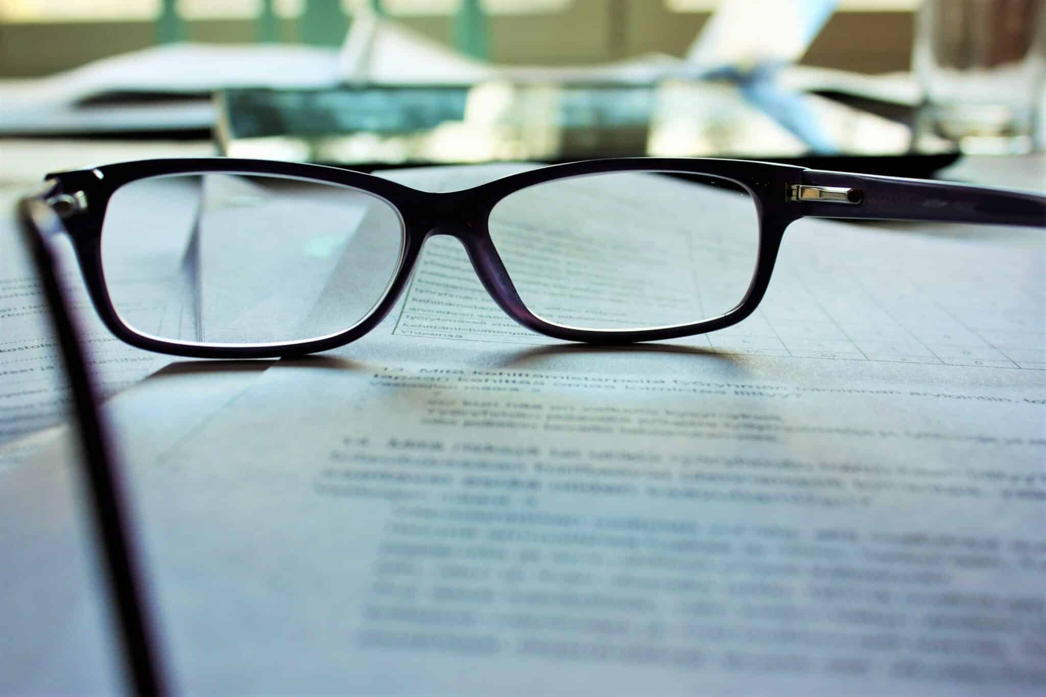 glasses on top of paperwork
