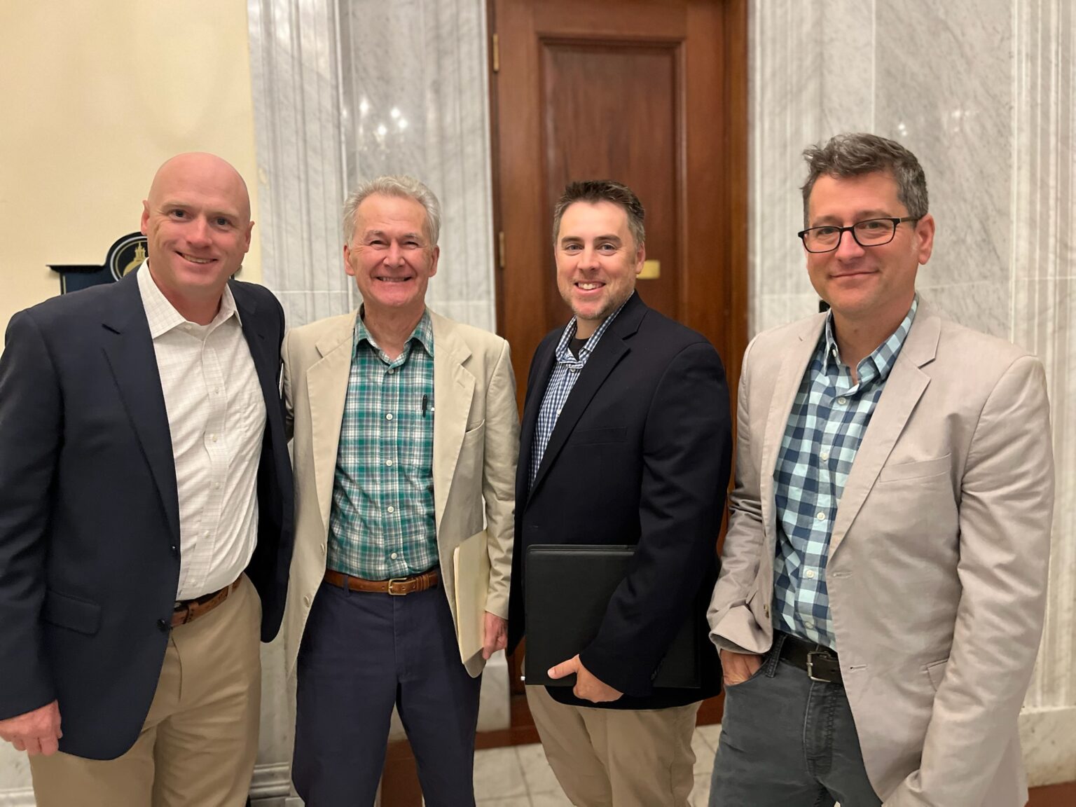 Home inspectors John Gallagher, Michael Atwell, Jameson Malgeri, and Morgan Cohen smile at the camera after promoting the pro-home inspection contingency Massachusetts bill together.