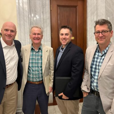 Home inspectors John Gallagher, Michael Atwell, Jameson Malgeri, and Morgan Cohen smile at the camera after promoting the pro-home inspection contingency Massachusetts bill together.
