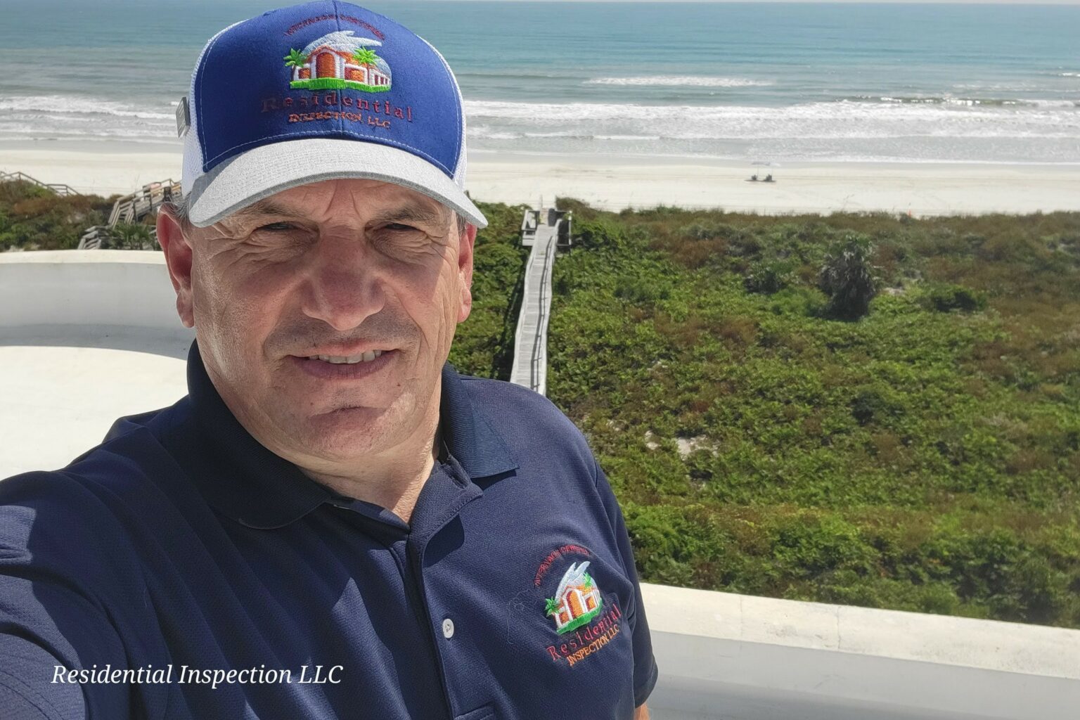 Photo of home inspector Vince Cardone of Residential Inspection LLC in Florida on a roof by the beach.