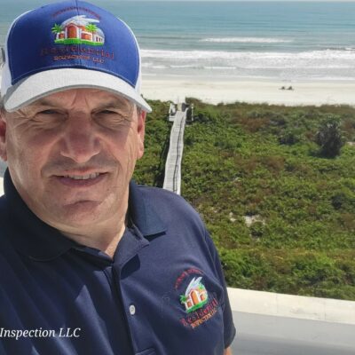 Photo of home inspector Vince Cardone of Residential Inspection LLC in Florida on a roof by the beach.