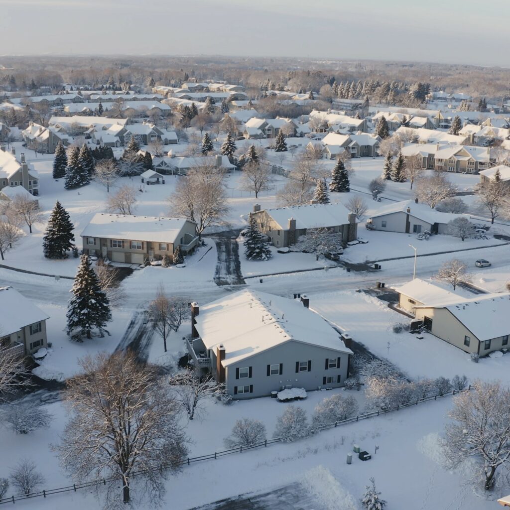 A neighborhood of condos blanketed in snow, as one might expect during cold weather home inspections.