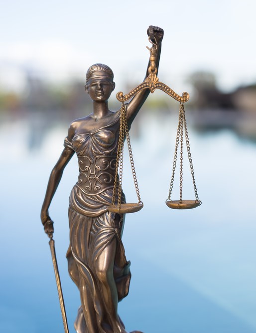 Statue of justice woman holding scales while blindfolded, illustrating the quandary inspectors fear if their home inspection report reveals problems.