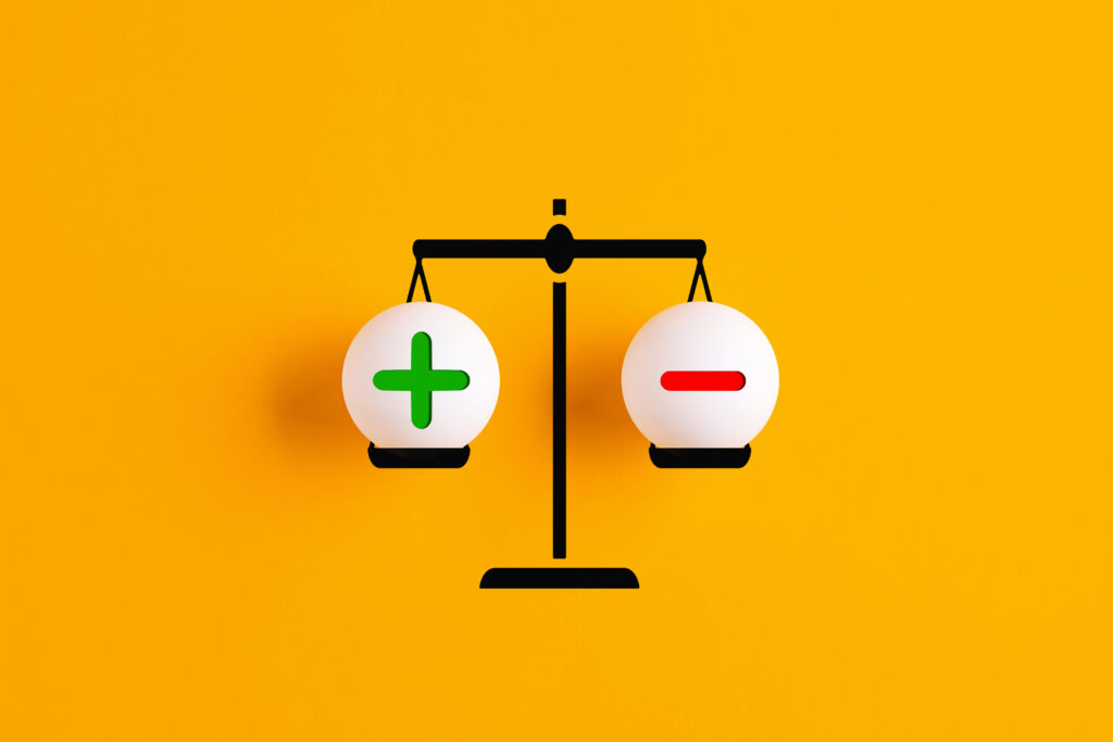 Illustration of a black scale against a yellow background, with a green plus sign on the left and a red minus sign on the right. Used to illustrate asking if home inspector is a good career and weigh the pros and cons of being a home inspector.