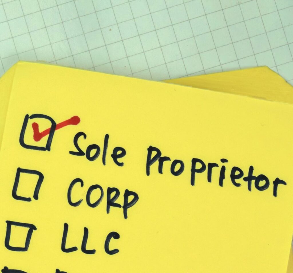 Stack of yellow sticky notes, the uppermost one reflecting what type of business is a home inspection entity, listing Sole Proprietor, Corp, and LLC with separate check boxes. Sole proprietor is checked off with a red marker.