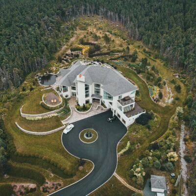 An aerial view of a higher square footage, luxury property with multiple stories, as one might see while performing big home inspections and inspecting huge houses.