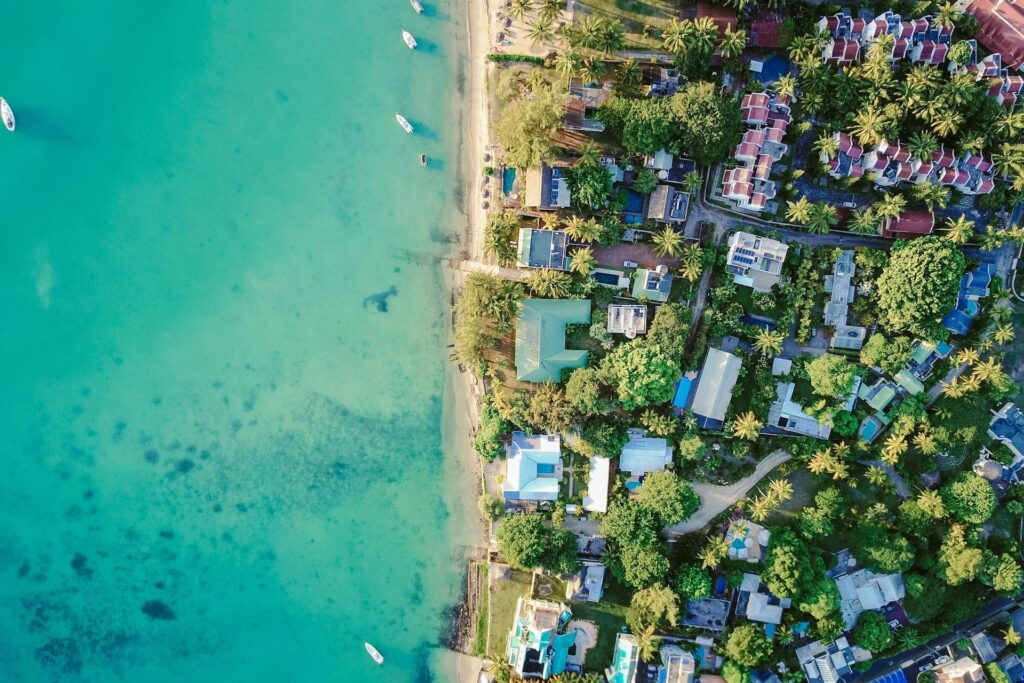 Aerial view of waterfront homes and homes by the beach.